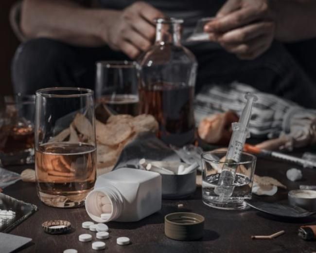 various drugs and alcoholic drinks on a table