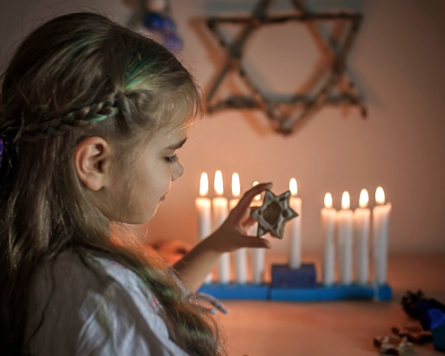 girl holding star of David cookie 