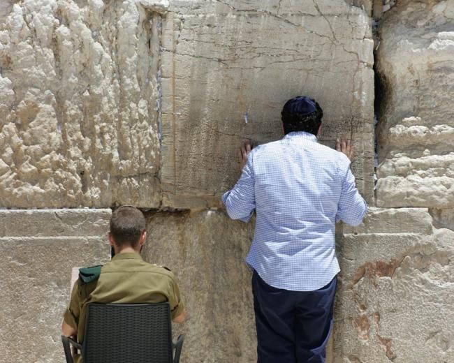 Two men pray at the Western Wall