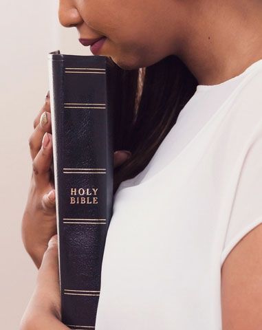 woman holds a bible close