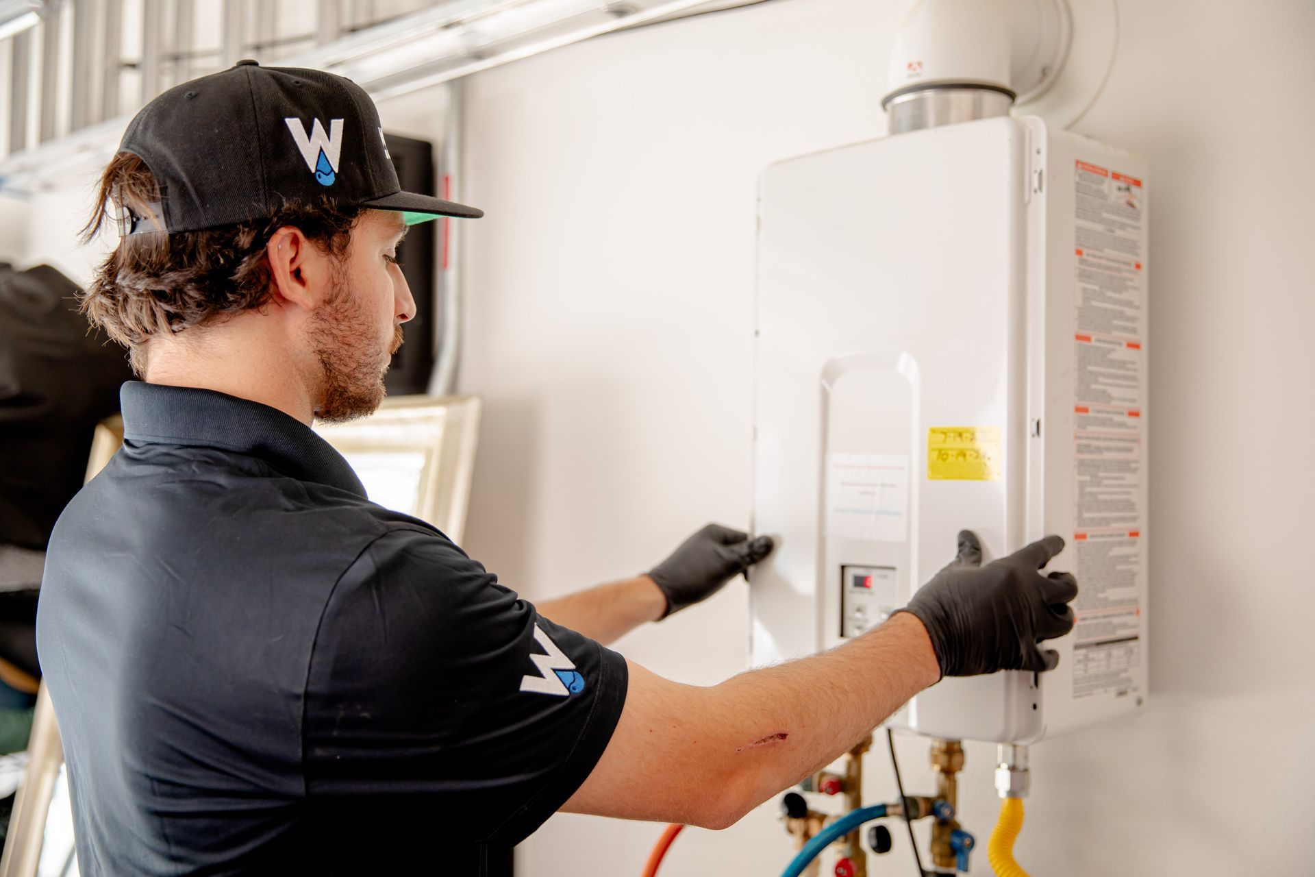 A woman is washing a child 's hair in a bathtub.