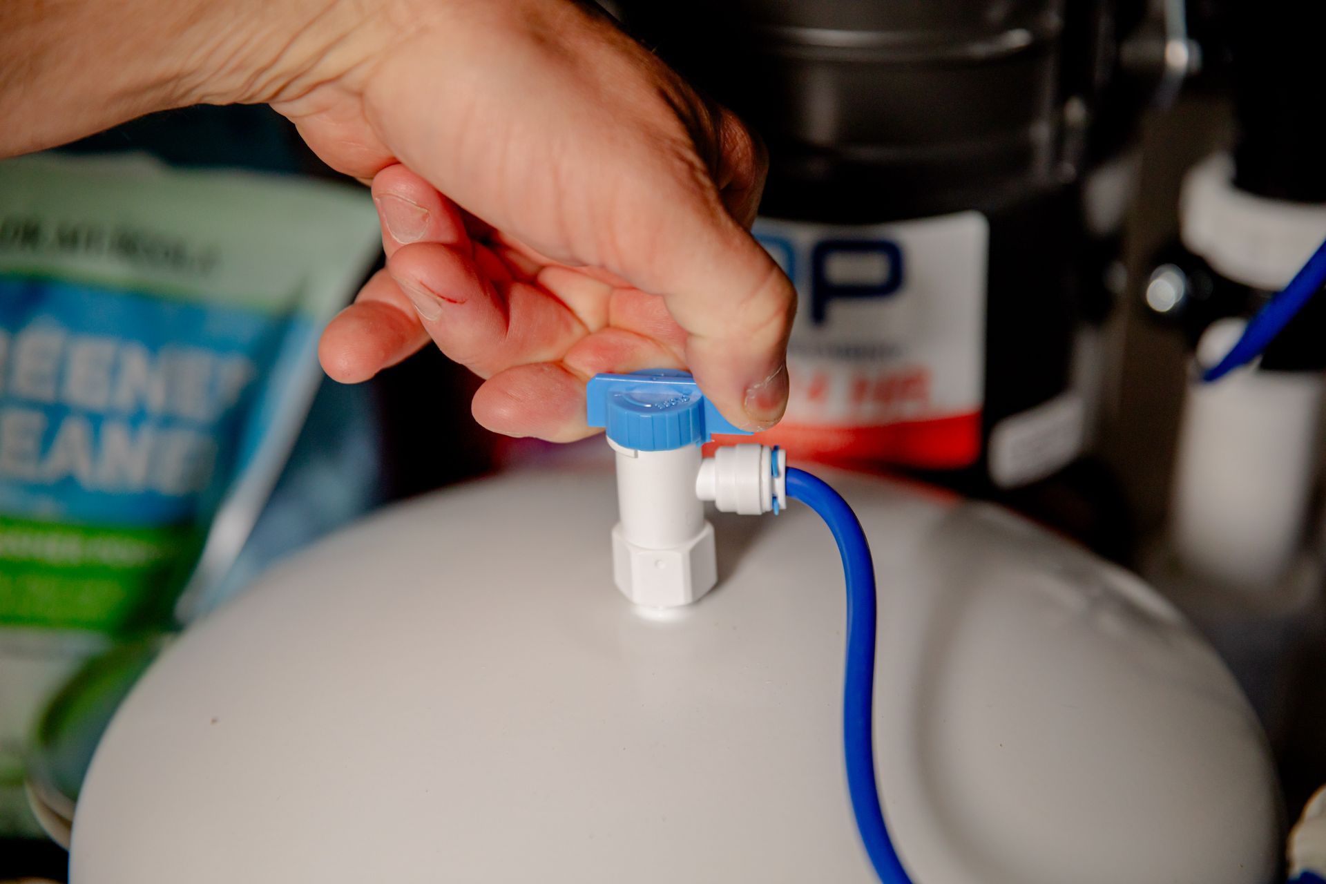 A pitcher of water and a glass of water on a kitchen counter.