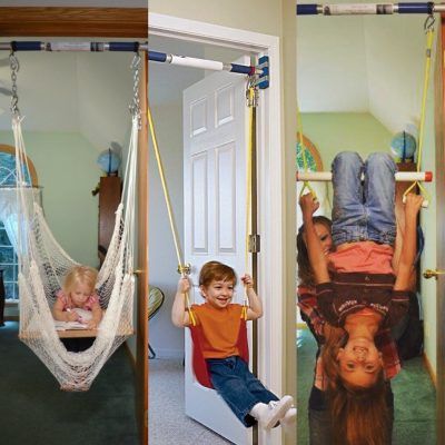 A boy and a girl are sitting on a swing in a doorway.