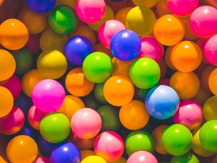 A pile of colorful plastic balls in a ball pit.