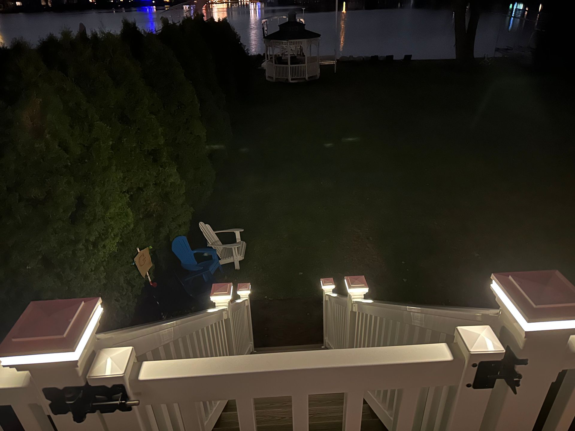 A view of a gazebo from a deck at night.