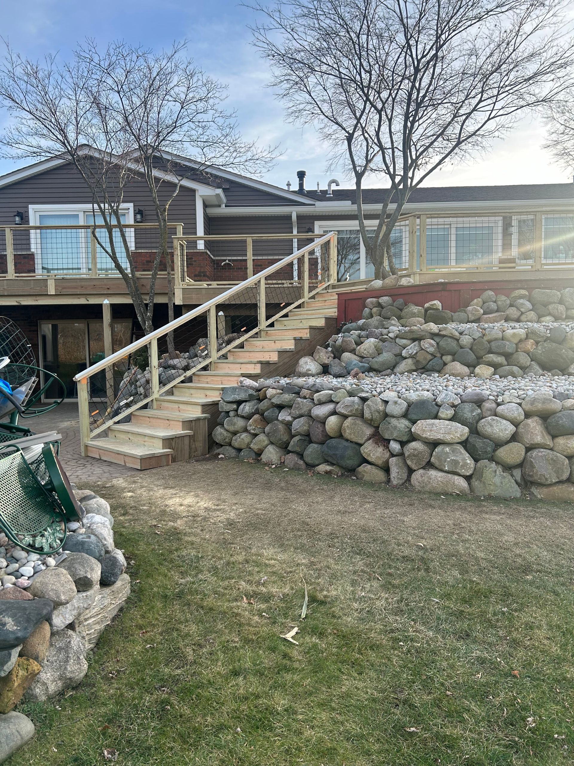 A house with a deck and stairs leading up to it.
