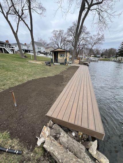 A wooden dock is being built next to a body of water.