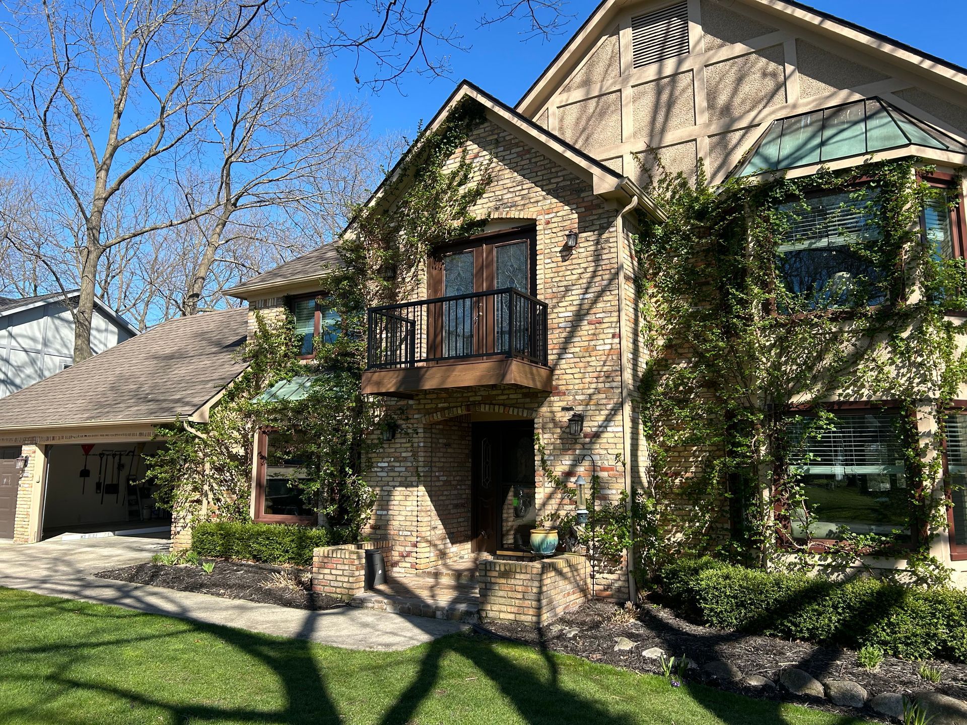 A large brick house with a balcony and a lot of windows.