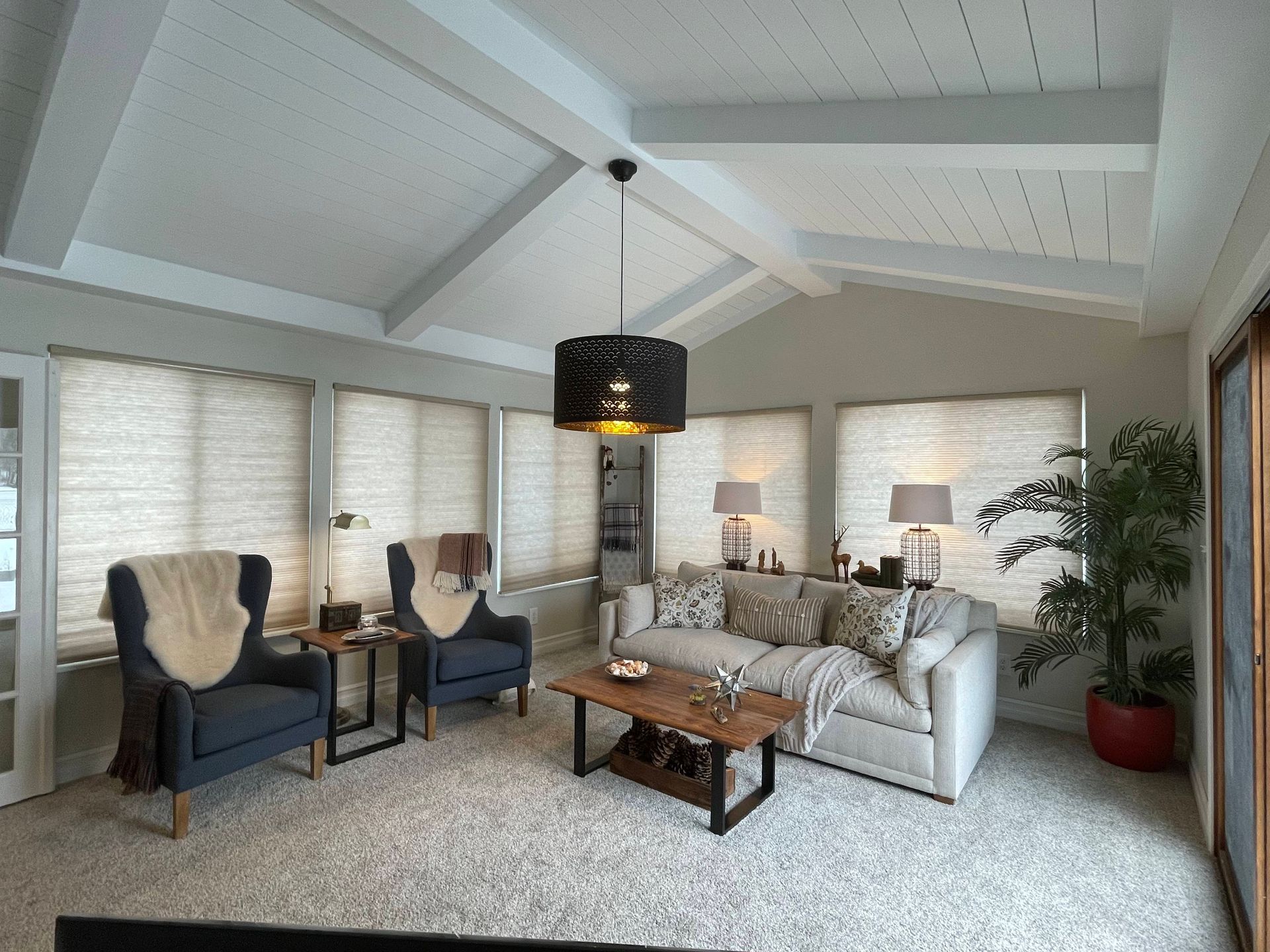 A living room with a couch chairs and a coffee table