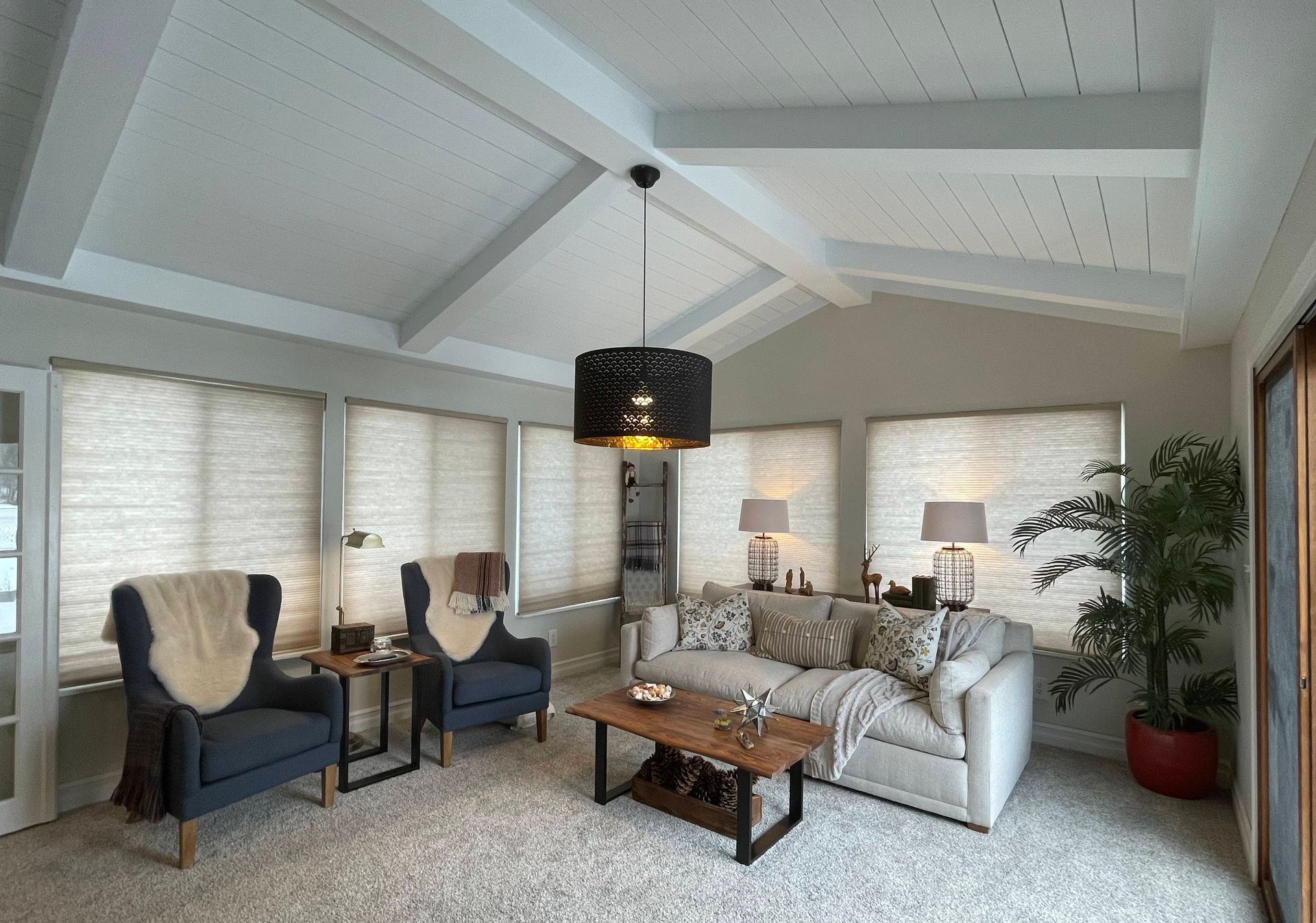 A living room with a couch chairs and a coffee table