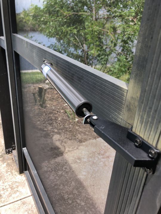 A close up of a window with a motor attached to it.