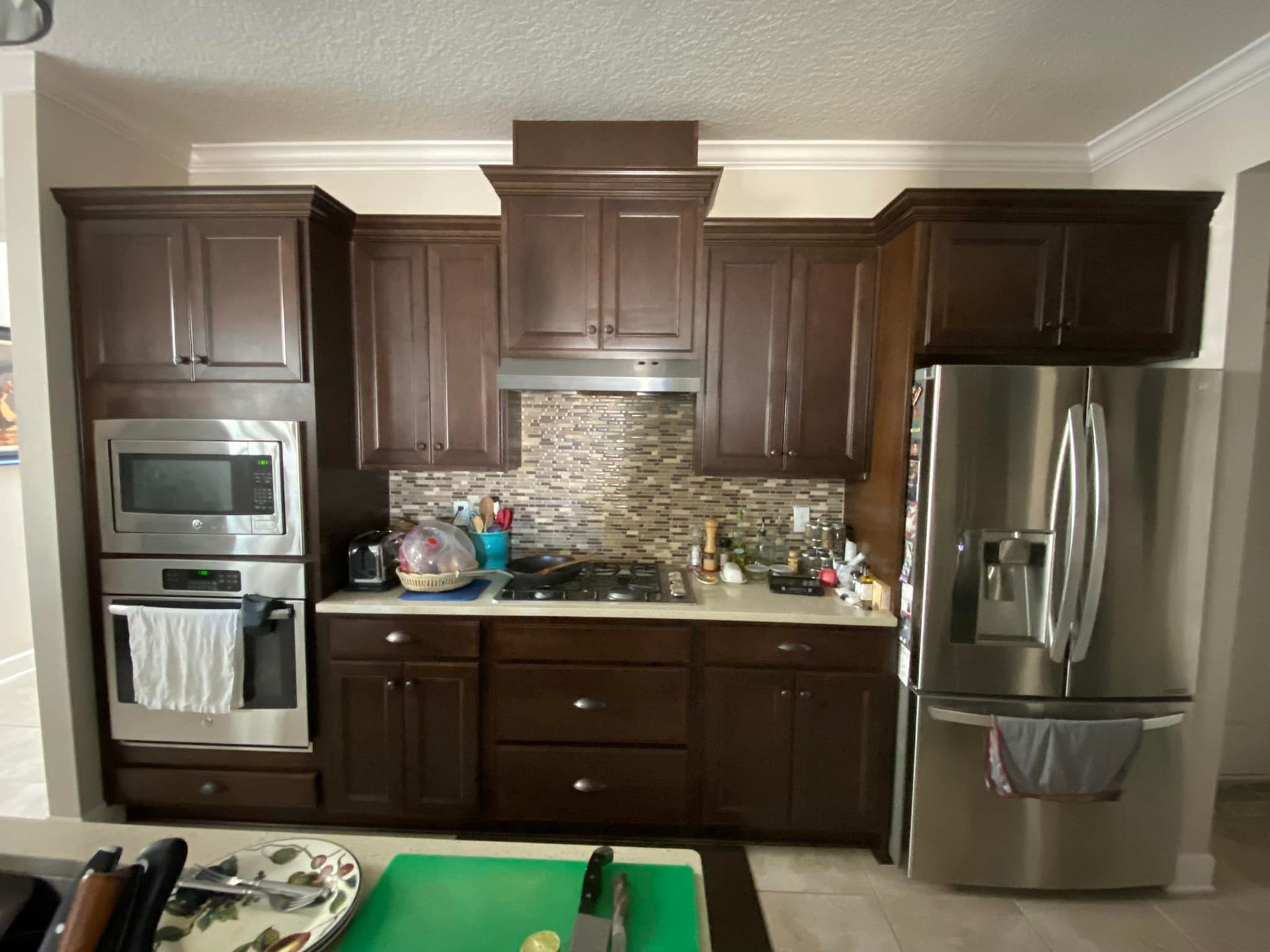 A kitchen with brown cabinets and stainless steel appliances