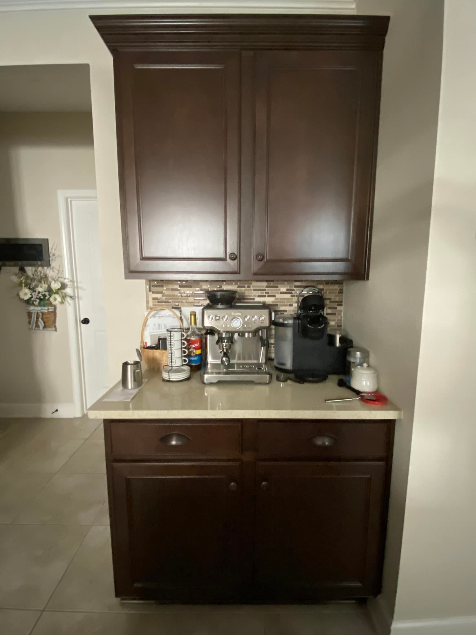 A kitchen with brown cabinets and a coffee maker on the counter.