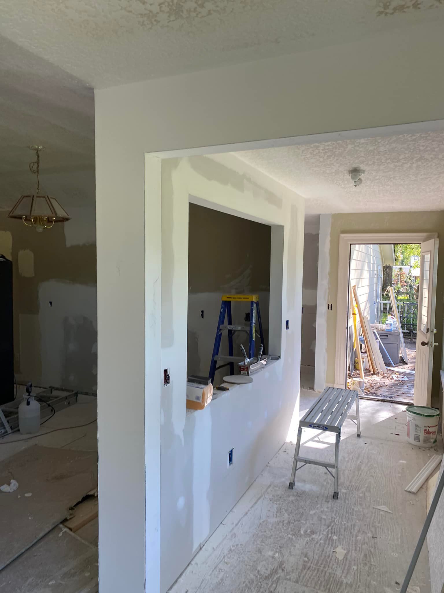 A room with a ladder and a bench in it.