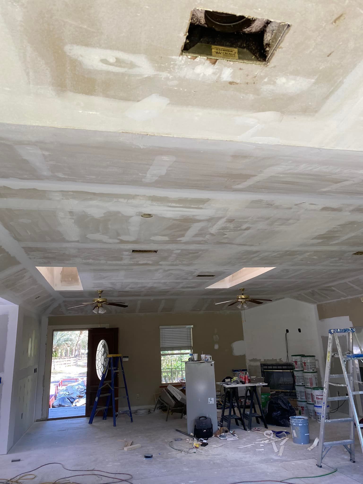 A room that is being remodeled with a hole in the ceiling