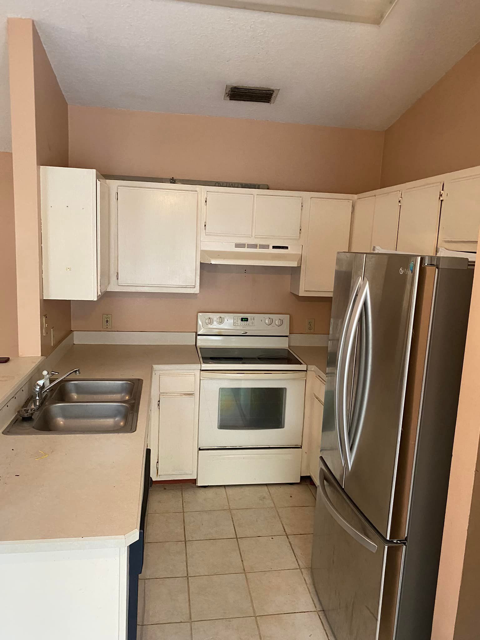 A kitchen with stainless steel appliances and white cabinets