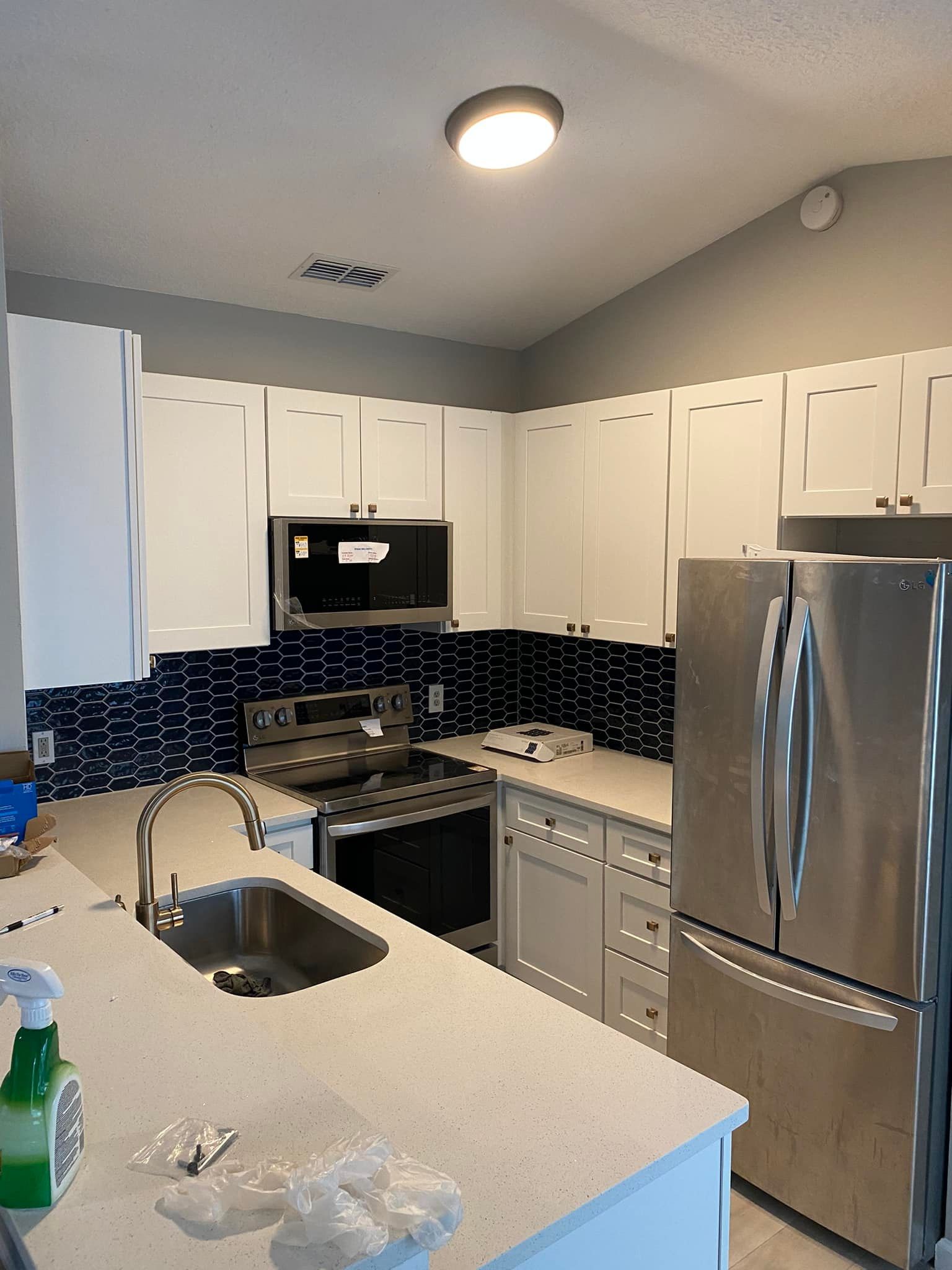 A kitchen with stainless steel appliances and white cabinets