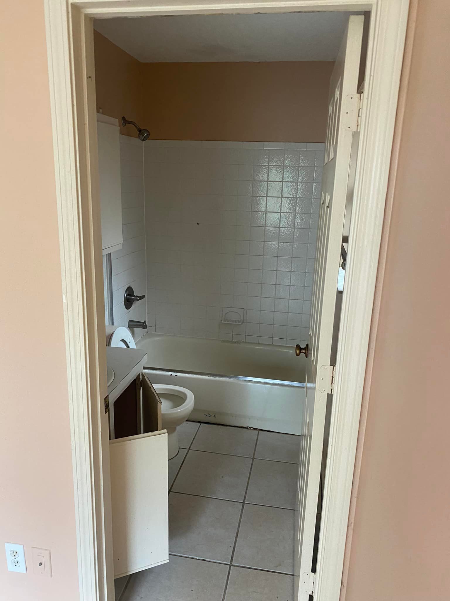 A bathroom with a sink , tub and shower.