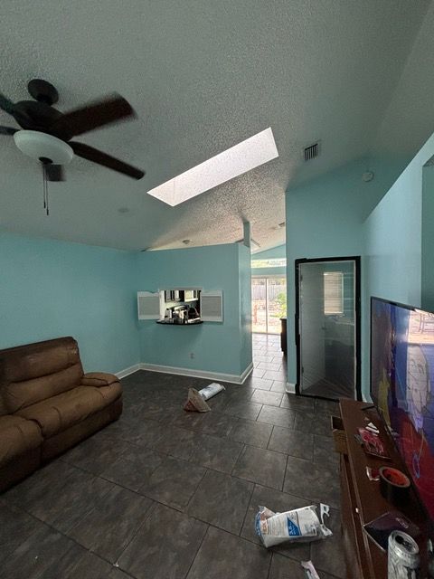 A living room with a ceiling fan and a couch