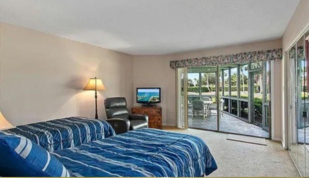 A bedroom with two beds and a television