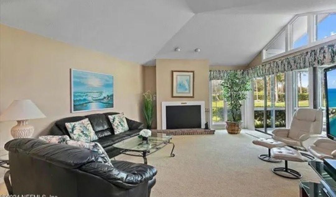 A living room filled with furniture and a fireplace.