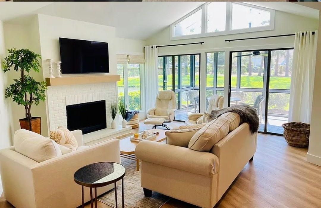 A living room filled with furniture and a fireplace.