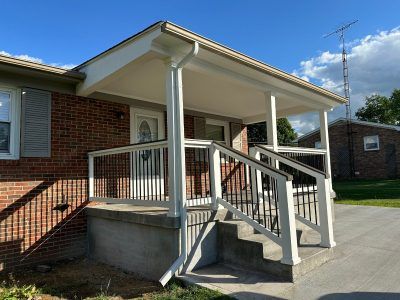 A brick house with a porch and stairs