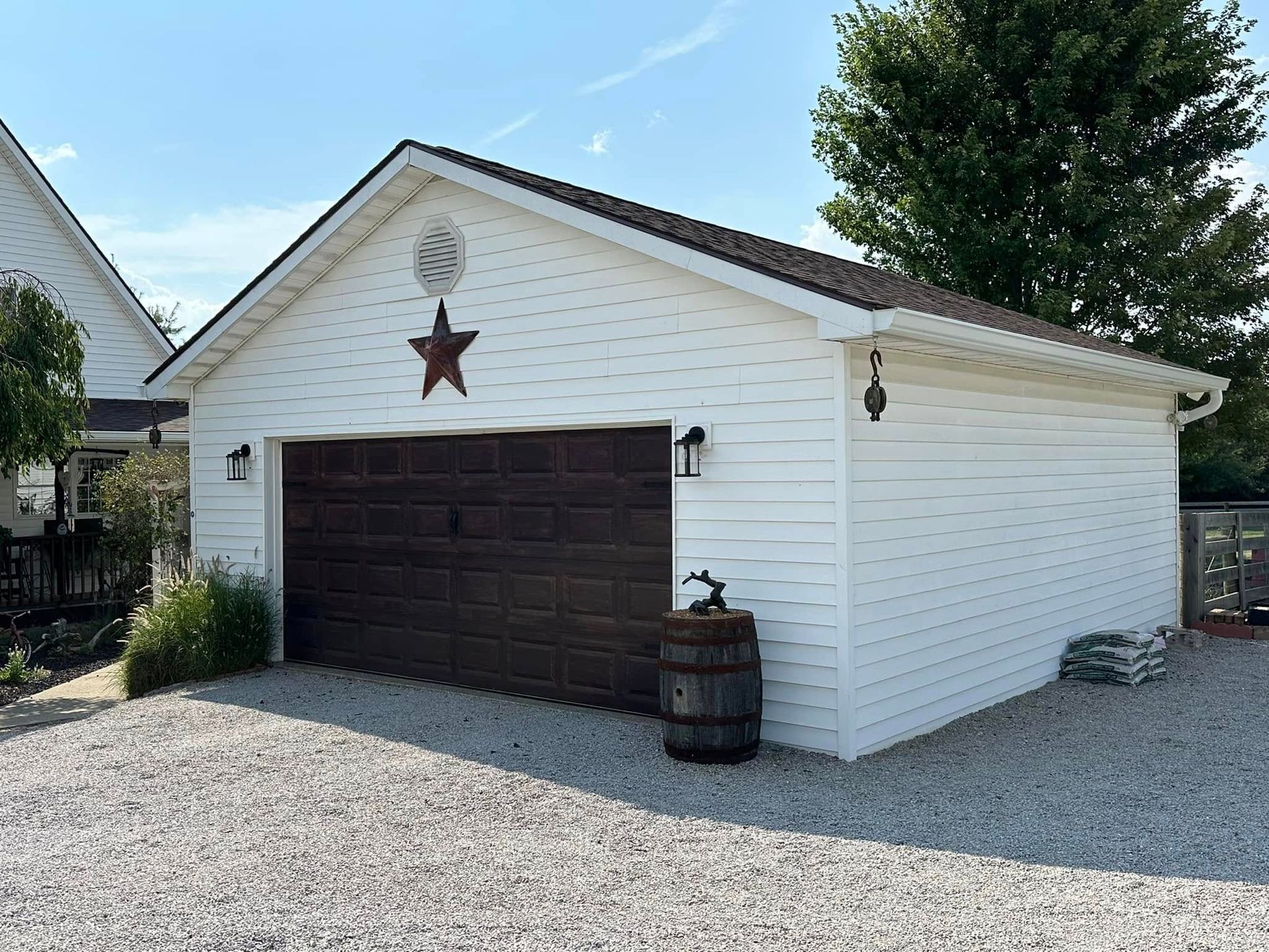 A white garage with a brown door and a star on it