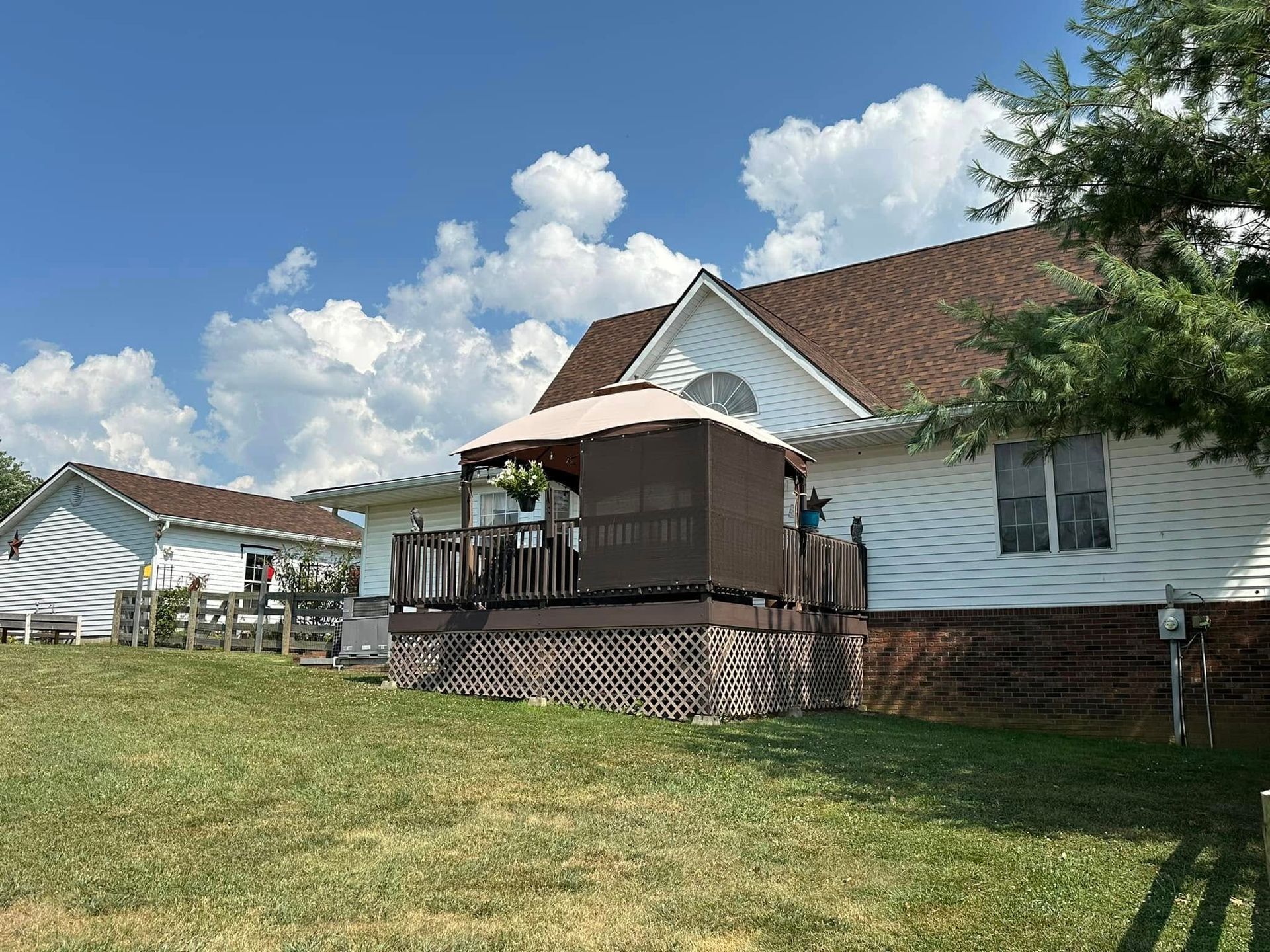 A white house with a gazebo in front of it.