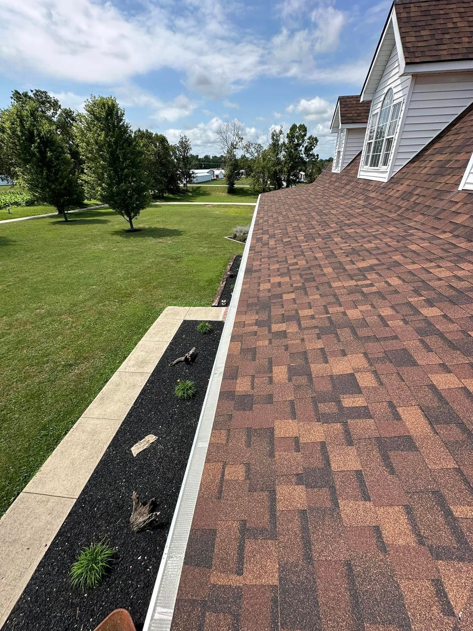 A house with a red roof and a gutter on the side of it.