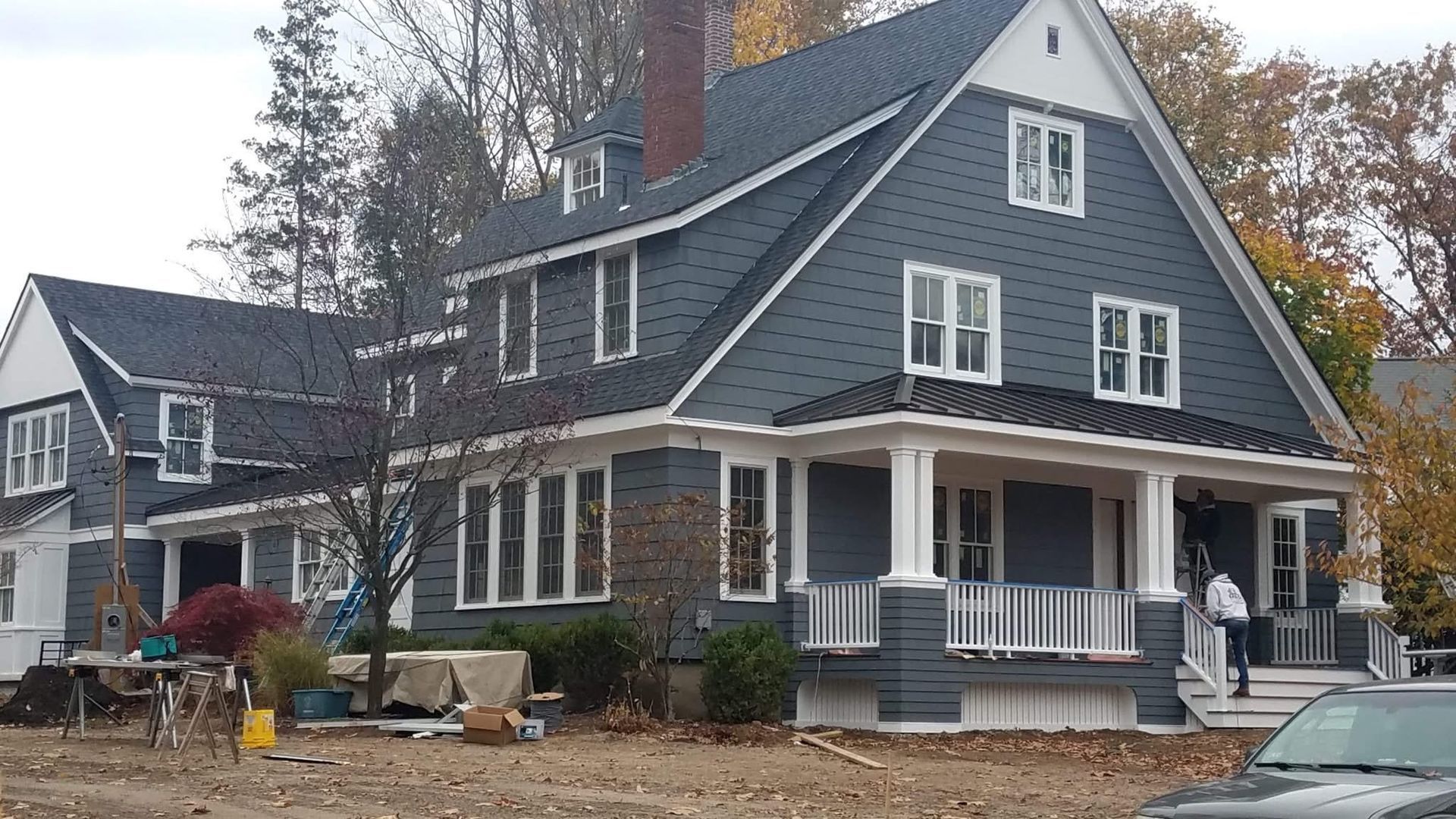 A large house with a car parked in front of it