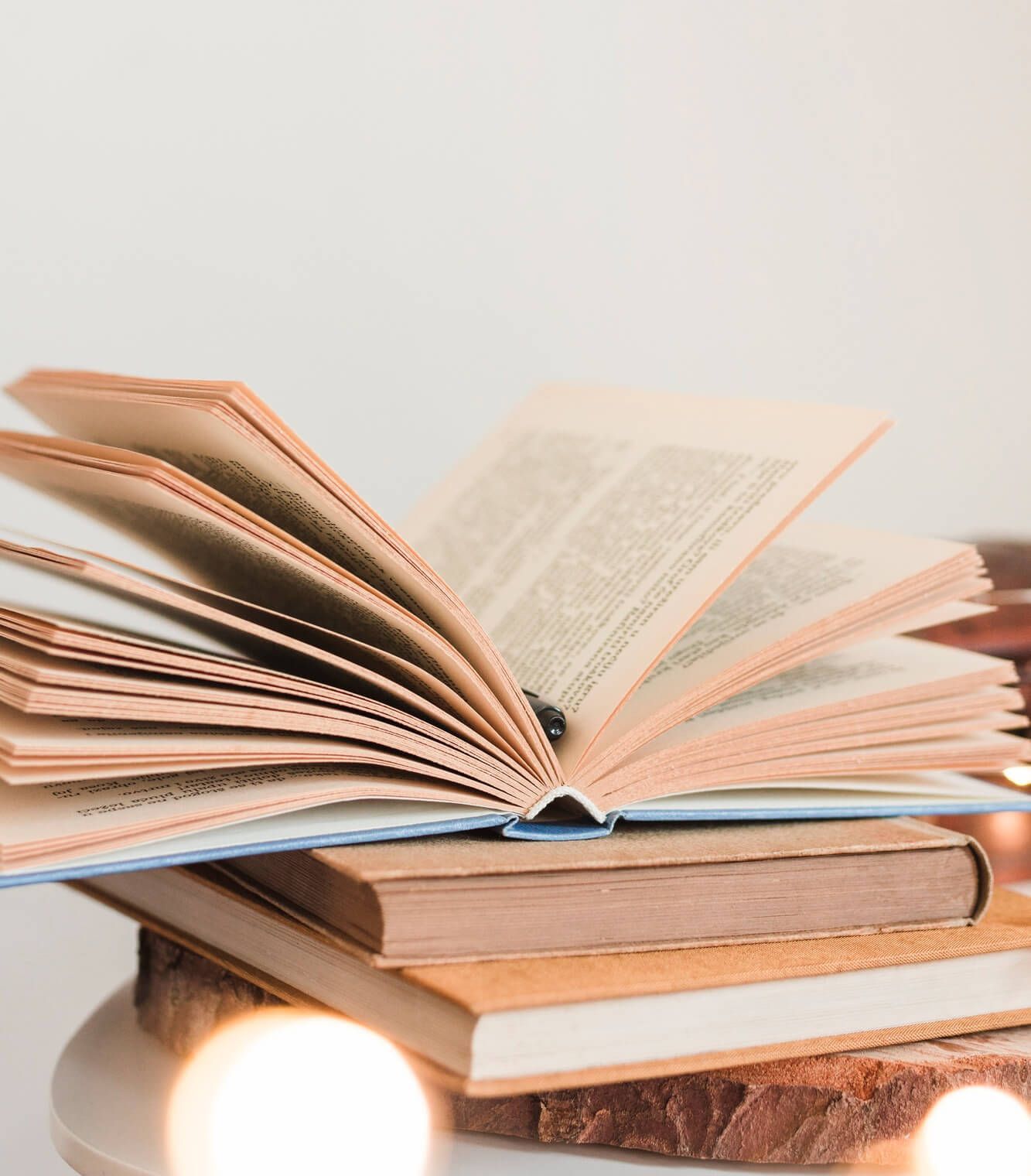 An Open Book on Top of A Stack of Books