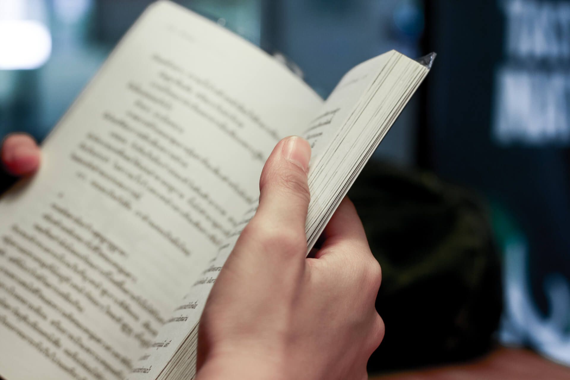 A Person Is Reading a Book in Their Hands