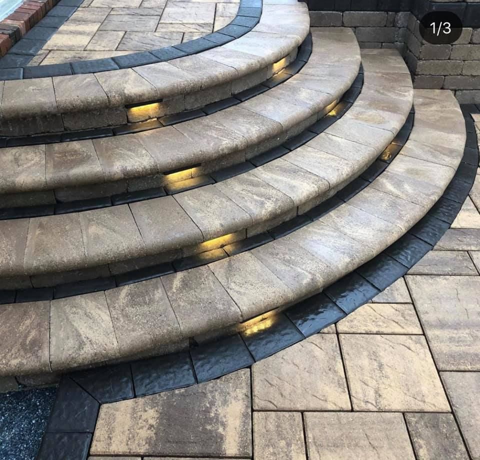 A set of stairs with lights on them are surrounded by bricks.