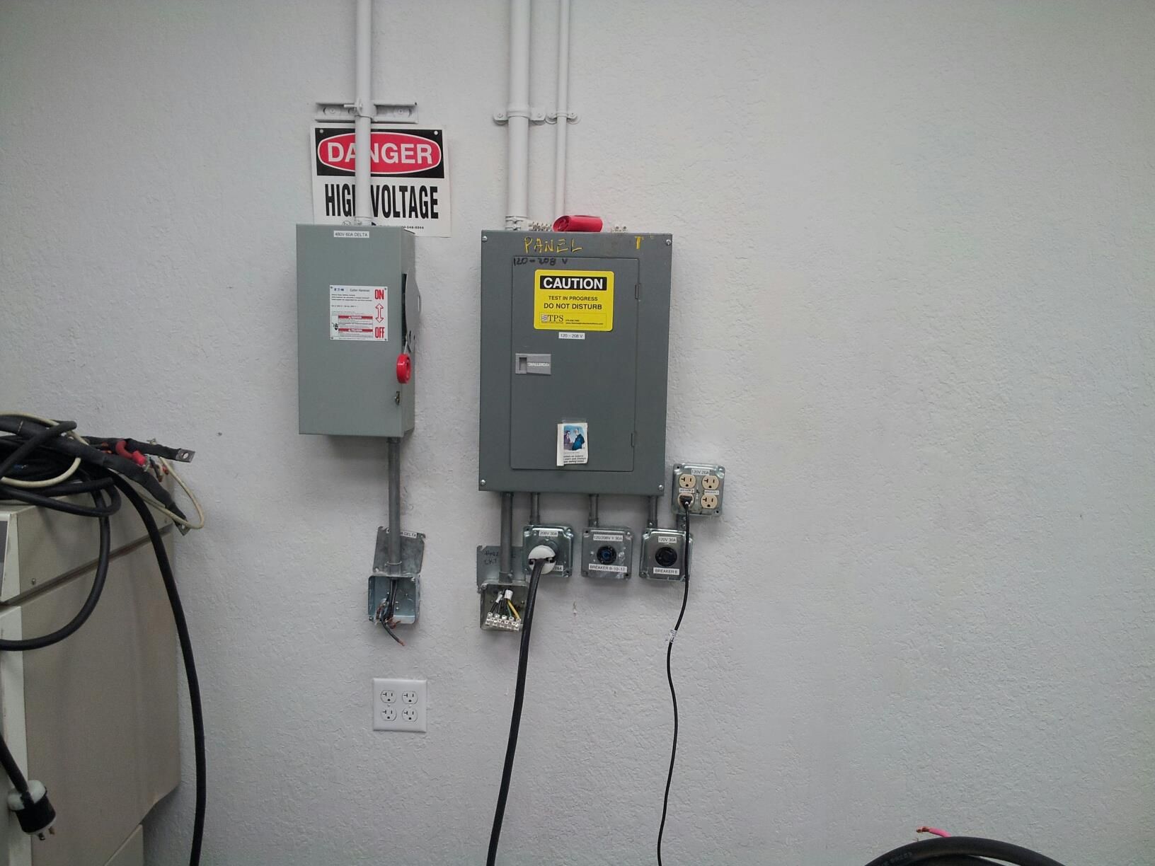 An electrical box with a danger sign above it