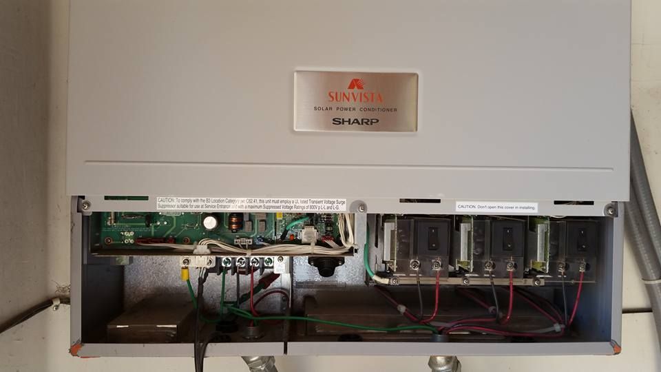 The inside of a solar panel inverter with the lid open.