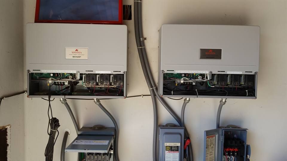 A couple of electrical boxes are hanging on a wall.