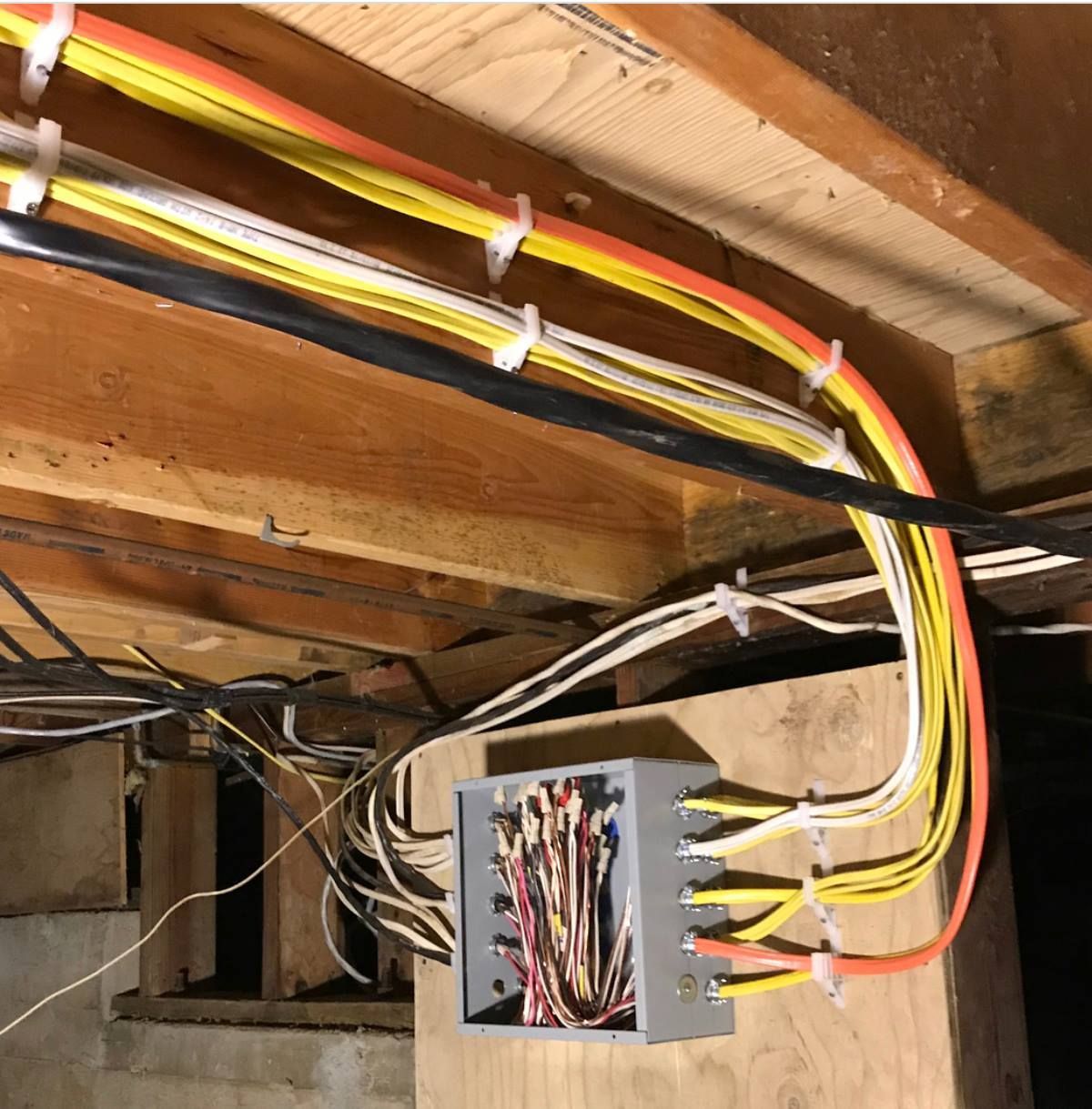 A bunch of wires are hanging from the ceiling