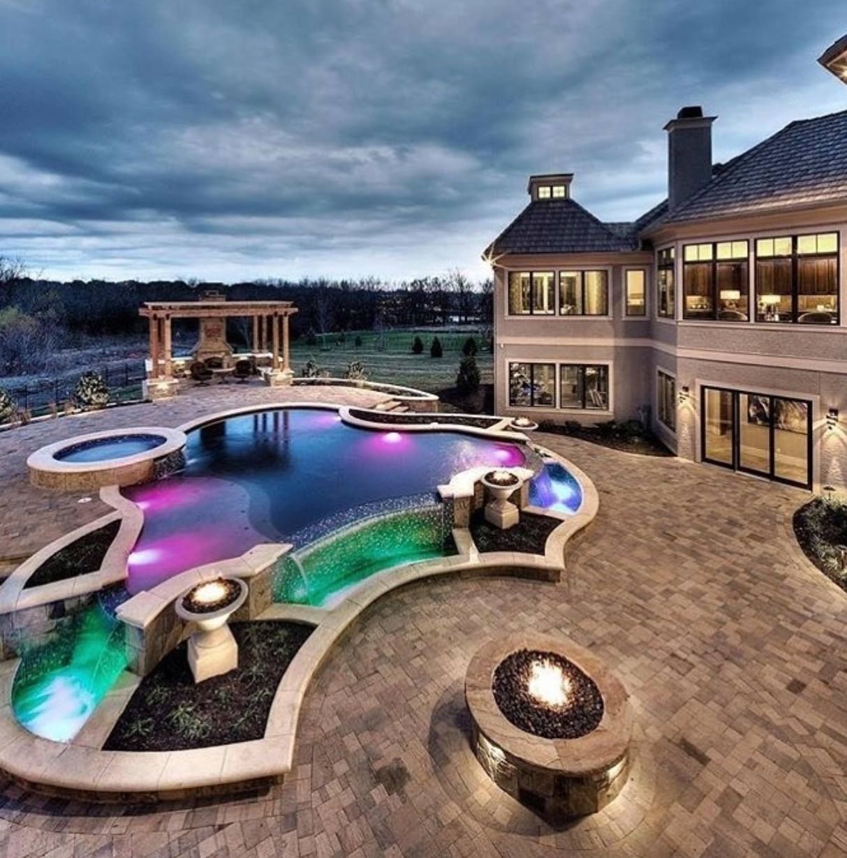 A large house with a large swimming pool in front of it