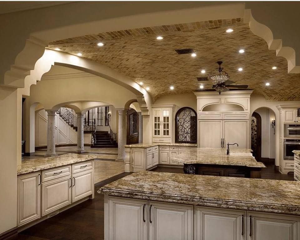 A kitchen with white cabinets and granite counter tops