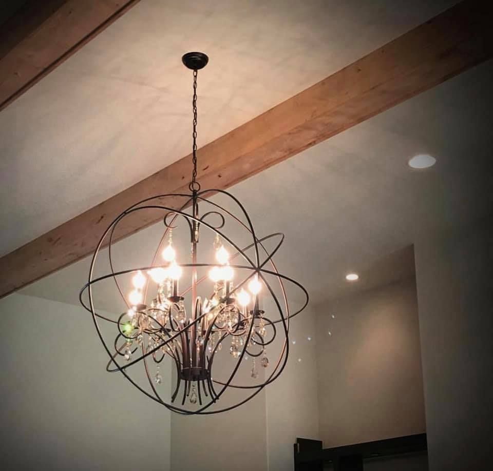 A chandelier is hanging from the ceiling in a room