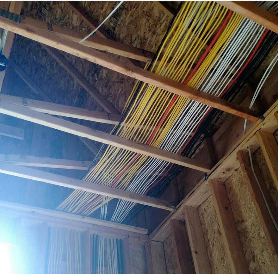 A bunch of wires are hanging from the ceiling of a building