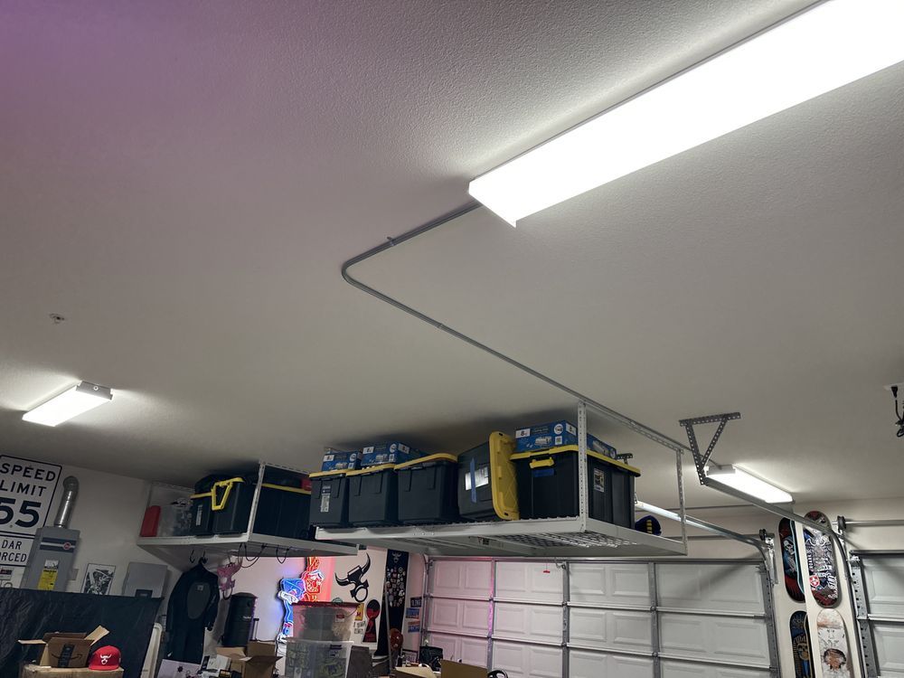 A garage with a lot of shelves and boxes on the ceiling.