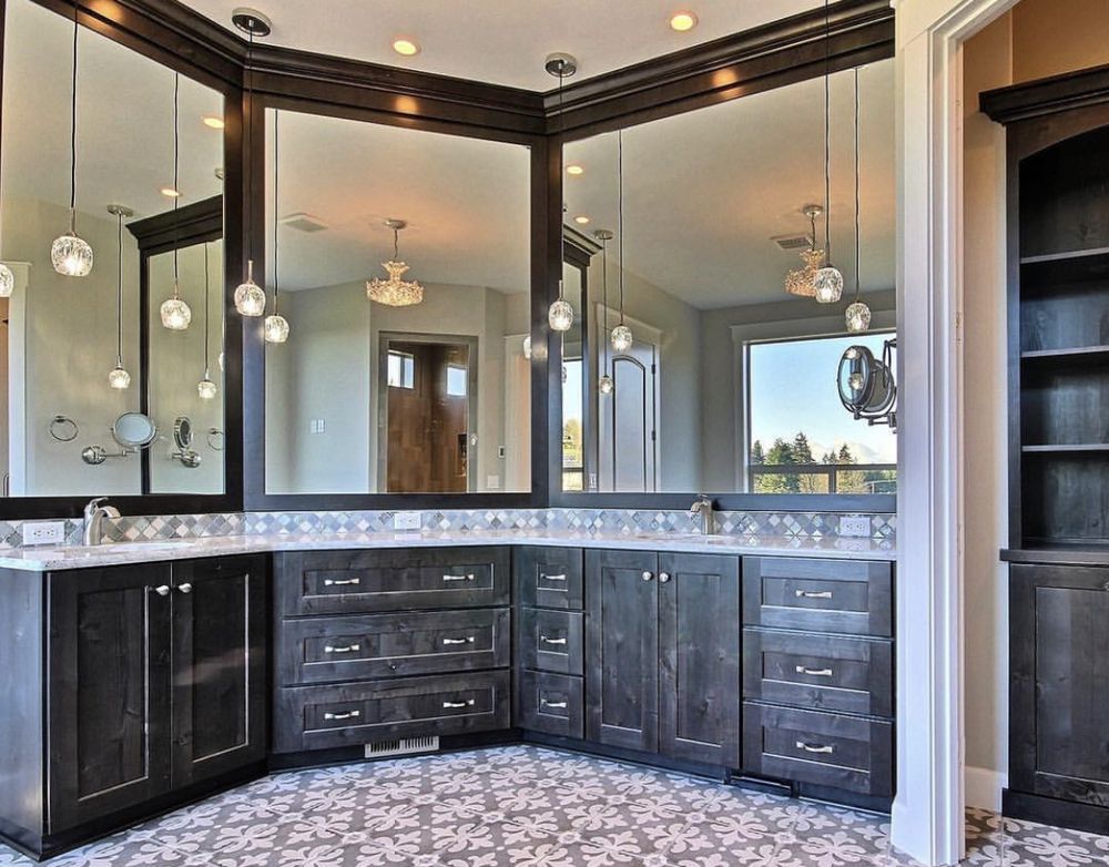A bathroom with two sinks and a large mirror