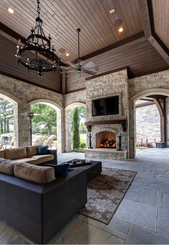 A living room with a fireplace and a chandelier