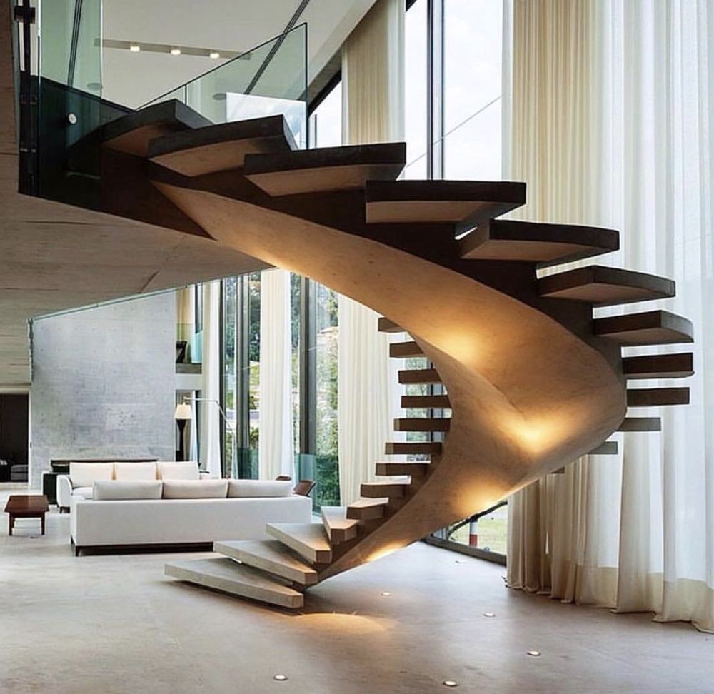 A spiral staircase is in the middle of a living room
