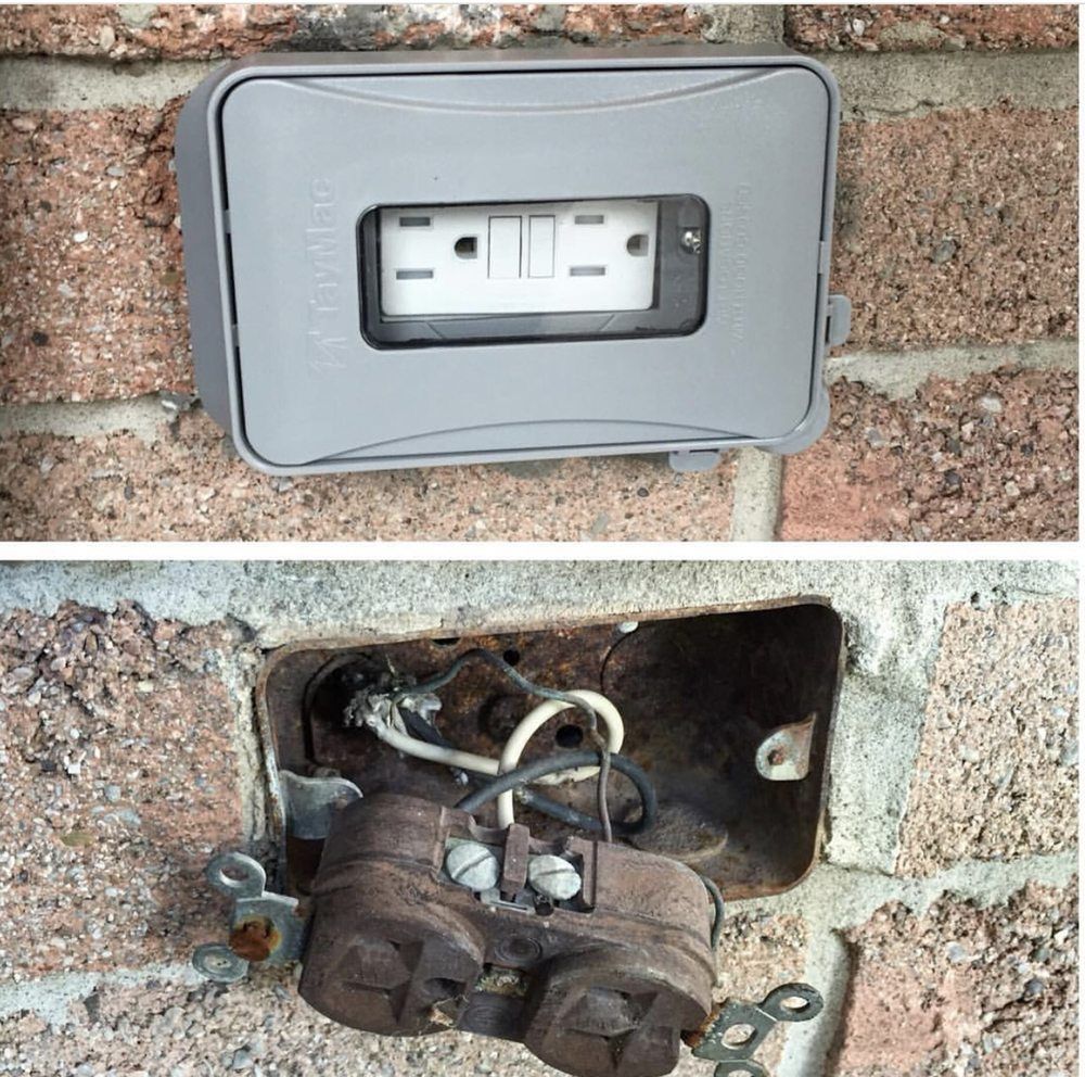 A picture of a electrical outlet on a brick wall