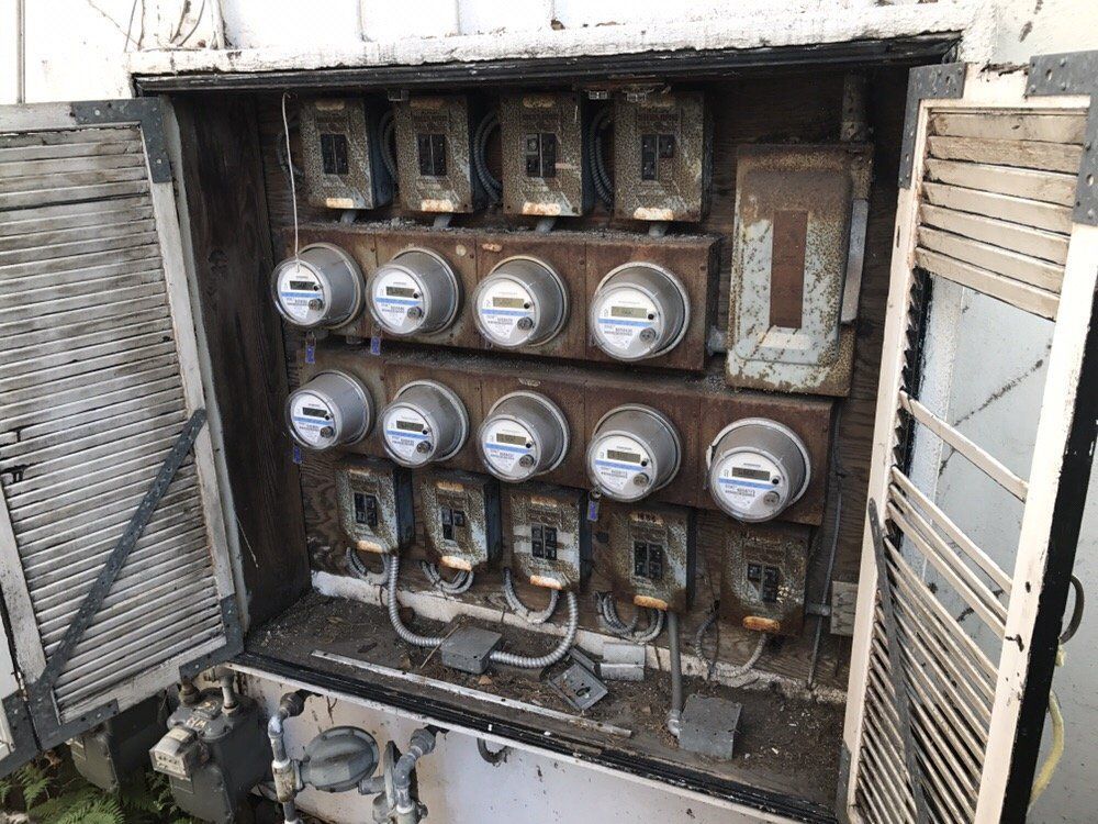 A very old electrical box with a lot of meters in it.
