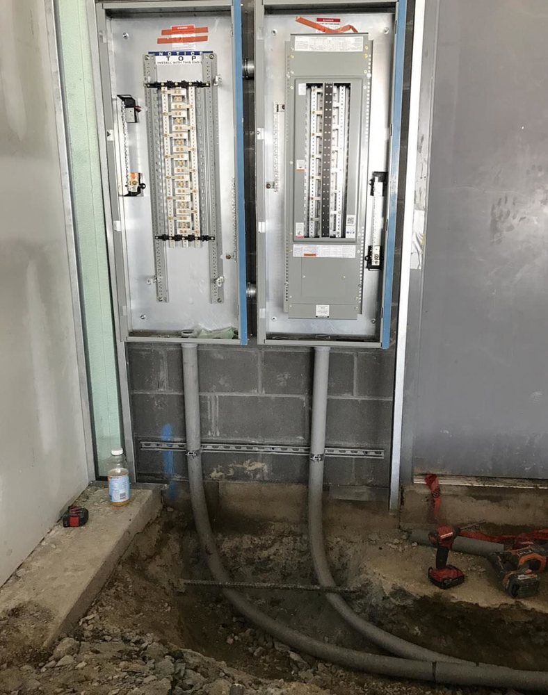 Two electrical boxes are sitting next to each other in a room.