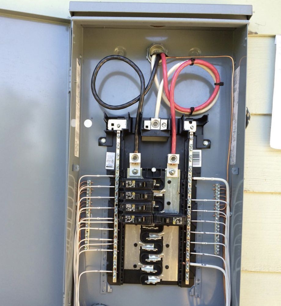 An open electrical box with a few wires coming out of it